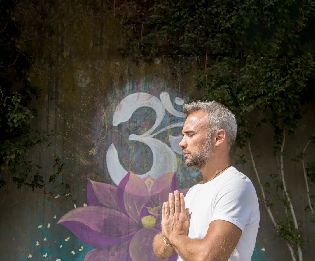 person in meditation doing the prayer sign with hands
