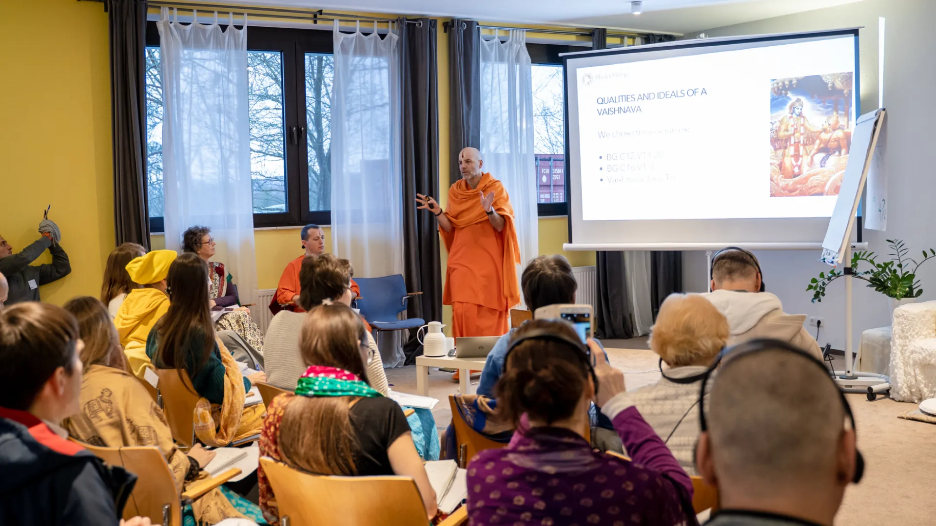 person teaching a seminar to a crowd of people